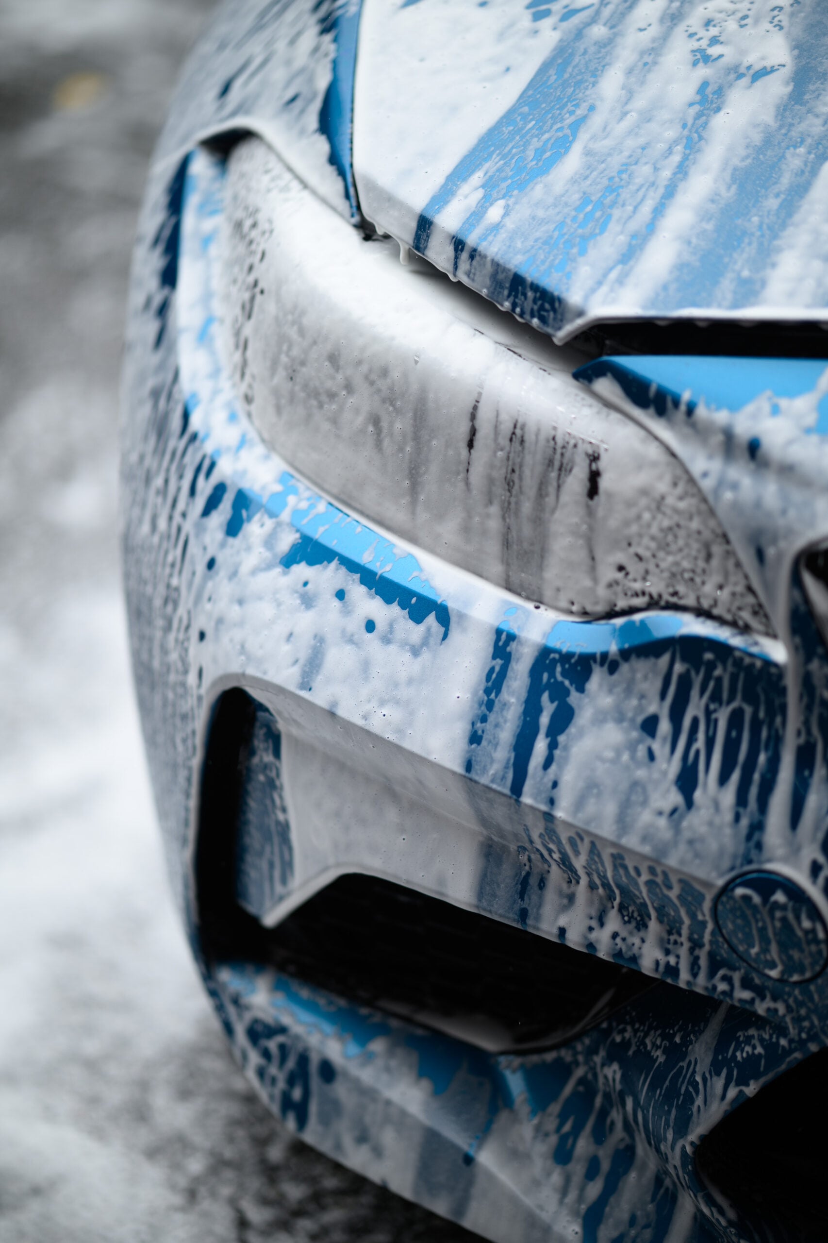 Active pre-wash foam breakdown on vehicle front fascia