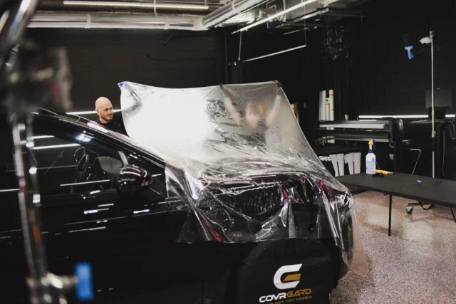 Hood installs take two people. Large panels like this get stretched and positioned together or you end up with wrinkles and bad adhesion. This one is bulk cut, which means we trim it on the car instead of using a pre-cut template.We do both bulk and computer cut depending on the car. Complex curves and body lines work better with bulk because you can adjust for tolerances. Simpler panels get pre-cut for speed. This Porsche Macan has enough contour that hand trimming gives us better edge alignment.#PPF #PaintProtectionFilm #PorscheProtection #AutoLust #ApexNC #CaryNC #PPFInstall #BulkInstall #CarDetailing #DetailingProcess #TriangleNC #919Cars #TeamWork #PorscheCary #ProfessionalDetailing